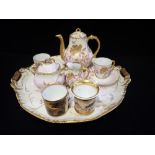 A FRENCH GILT PORCELAIN CABARET SET