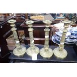 A SET OF FOUR CAST BRASS EMPIRE STYLE CANDLESTICKS