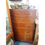 AN EDWARDIAN BOW-FRONT CHEST OF DRAWERS
