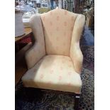 A GEORGE III STYLE WING ARMCHAIR