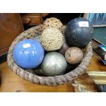 A BASKET CONTAINING VARIOUS DECORATIVE BALLS