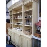 A GEORGE III STYLE BREAKFRONT OPEN BOOKCASE