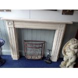 A RE-CONSTITUTED STONE FIREPLACE SURROUND