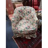 AN EDWARDIAN UPHOLSTERED TUB CHAIR