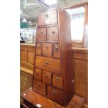 A TEAK CHEST OF DRAWERS