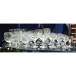 A COLLECTION OF FACETED DRINKING GLASSES