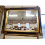 A PAINTED AND GILT FRAMED WALL MIRROR