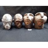 FOUR WOODEN TRIBAL HEADS