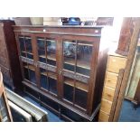 AN EDWARDIAN MAHOGANY GLAZED BOOKCASE, WITH CARVED DECORATION