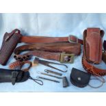 A COLLECTION OF AMMUNITION BELTS, HOLSTERS, A BULLET MOULD