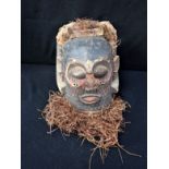 ETHNOGRAPHICA: A TRIBAL MASK OR HEADDRESS, FORMED IN THE ROUND FROM WOOD