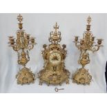 A CAST BRASS CLOCK GARNITURE