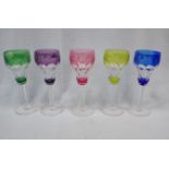 FIVE COLOURED, FACETED, AND ENGRAVED WINE GLASSES