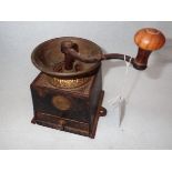 A VICTORIAN CAST IRON AND BRASS COFFEE GRINDER