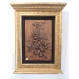 A WALNUT PANEL, CARVED WITH A BUNCH OF FLOWERS