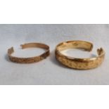 TWO ROLLED GOLD BANGLES