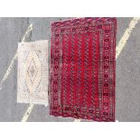 A RED GROUND PERSIAN DESIGN RUG