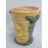 A POTTERY FOUR-HEADED CUP