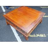 A LARGE CONTEMPORARY HARDWOOD COFFEE TABLE