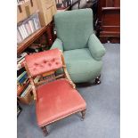 AN EDWARDIAN UPHOLSTERED ARMCHAIR