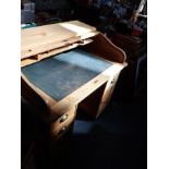 A 1920S PALE OAK ROLL-TOP DESK