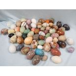 A LARGE COLLECTION OF POLISHED MARBLE, ONYX AND STONE EGGS