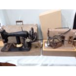 A VINTAGE SEWING MACHINE WITH METAL CASE