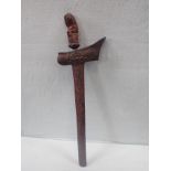 A KRIS, WITH PROFUSELY CARVED SCABBARD AND GRIP