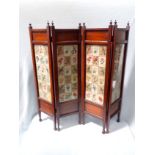 AN EDWARDIAN MAHOGANY FOUR-FOLD FIRESCREEN