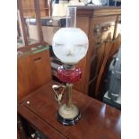 A VICTORIAN OIL LAMP WITH CRANBERRY GLASS FONT