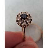 A 9 CT GOLD RING FLOWER SET WITH STONES
