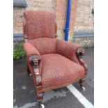 A VICTORIAN WALNUT FRAMED UPHOLSTERED ARMCHAIR, WITH LION MASK CARVED ARMS