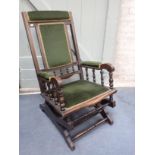 AN EDWARDIAN 'BOSTON' ROCKING CHAIR