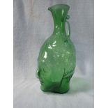 A GREEN GLASS JUG, BLOWN IN THE FORM OF A HEAD