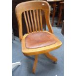 AN EDWARDIAN OAK SWIVEL DESK CHAIR