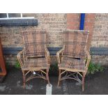 A PAIR OF EDWARDIAN RATTAN ARM CHAIRS BY MAPLE & CO
