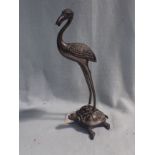 A CAST BRONZE STORK STANDING ON A TORTOISE