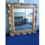 A MOULDED AND GILT FRAMED MIRROR
