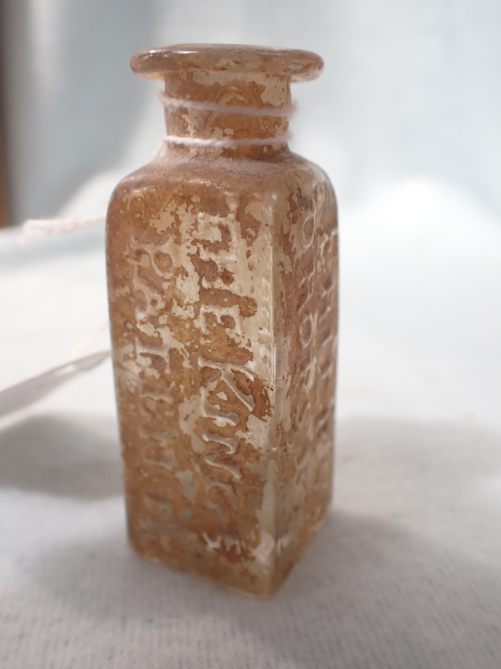 AN 18TH CENTURY MOULDED GLASS MEDICINE JAR