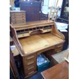 A GOLDEN OAK ROLL-TOP DESK