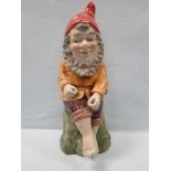 A REPRODUCTION GLAZED CERAMIC GARDEN GNOME