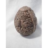 A MOULDED CLAY 'EGG' DEPICTING THE NATIVITY