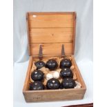 A VINTAGE PINE-CASE LAWN BOWLING SET ; THE 'BUNGALOW'