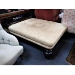 A LARGE UPHOLSTERED COUNTRY HOUSE FOOTSTOOL