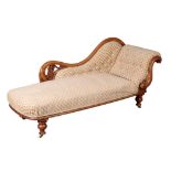 A VICTORIAN CARVED WALNUT UPHOLSTERED CHAISE LONGUE