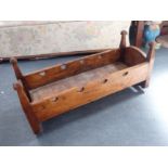 AN 18TH CENTURY ELM AND PINE CHILD'S BED