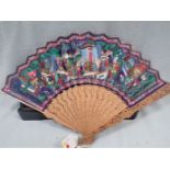 A CANTONESE FAN WITH CARVED GUARDS AND PAINTED WITH SCENES