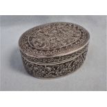 AN INDIAN WHITE METAL OVAL BOX
