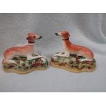 A SMALL PAIR OF 19TH CENTURY STAFFORDSHIRE GREYHOUNDS