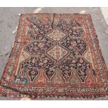 A PERSIAN STYLE RUG WITH STYLISED ANIMALS AND PLANT DECORATION